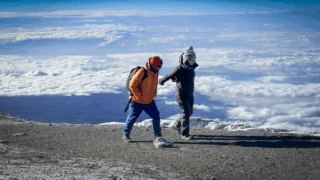 Life Happens Outdoors mother and daughter community members preparing to attempt Aconcagua with the mountain in the distance.