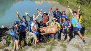 Life Happens Outdoors community members celebrating their arrival into Italy on the Tour du Mont Blanc trek.