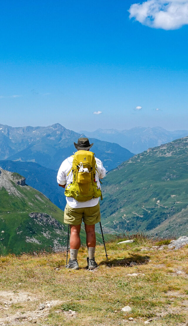 Tour du Mont Blanc trekker from Life Happens Outdoors looking out over the Alps toward the horizon during a guided hiking adventure