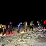 Life Happens Outdoors team starting Kilimanjaro summit night in the dark with headlamps and a slow steady pace.