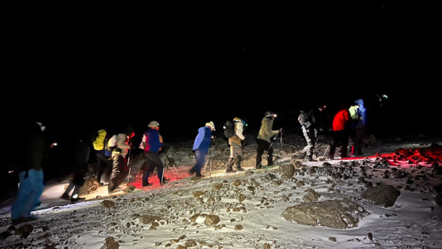 Life Happens Outdoors team starting Kilimanjaro summit night in the dark with headlamps and a slow steady pace.
