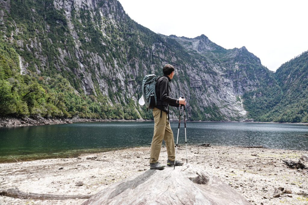 Life Happens Outdoors community member in northern Patagonia beside a turquoise lake with mountain scenery behind.