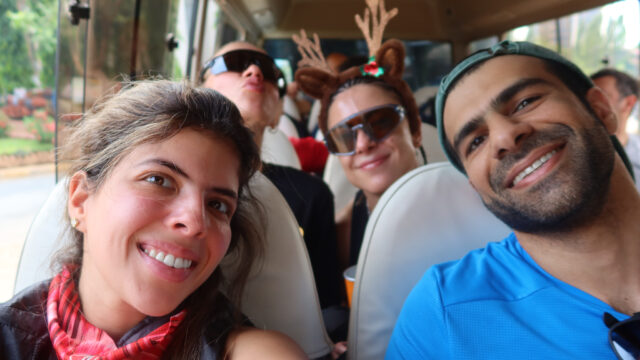 An adult traveller smiling on a mountain trail, rediscovering play, freedom, and exploration with Life Happens Outdoors.