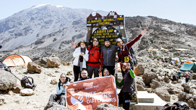 Life Happens Outdoors community members celebrating arrival at Barafu Camp, the summit base camp on Kilimanjaro.