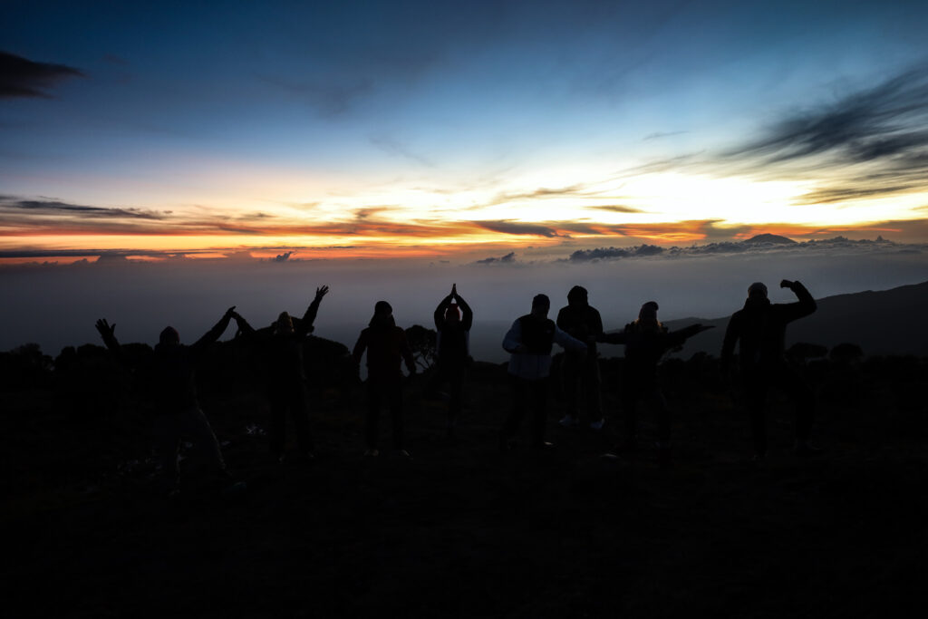 Life Happens Outdoors community members at Karanga Camp watching sunset on Kilimanjaro