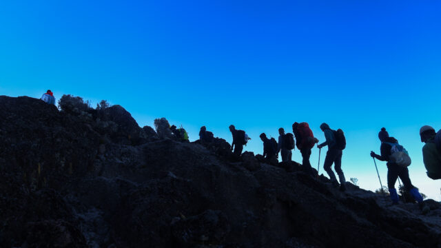 Life Happens Outdoors community members trekking in the early hours toward Lava Tower on the Machame Route on Kilimanjaro