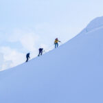 Roped climbers with a guide ascending Mont Blanc in snowy conditions
