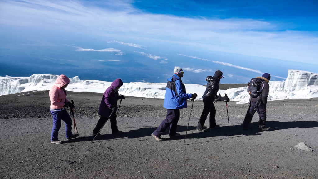 Group of climbers trekking near Kilimanjaro’s summit glaciers
