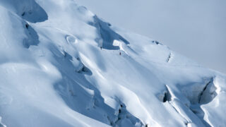 Climbers crossing crevassed glacier terrain during a mountaineering trip in the Alps