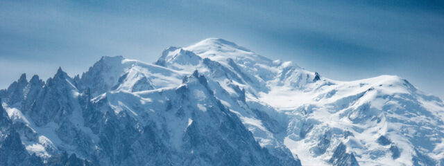 Snow covered alpine peak seen from a mountain trail during a hiking trip in the Alps