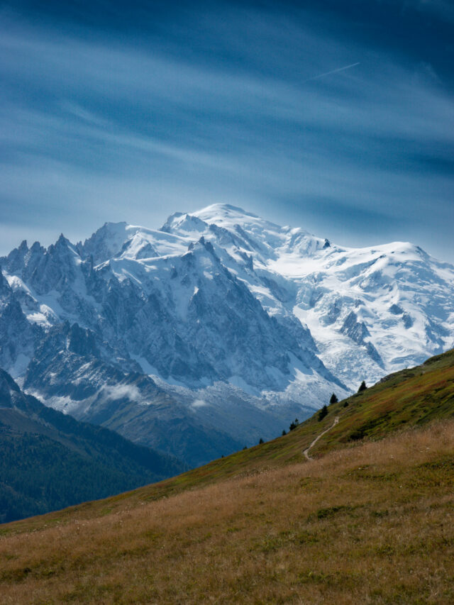 Snow covered mountain above an alpine trail during a guided hiking holiday in the Alps