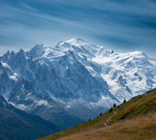 Snow covered mountain above an alpine trail during a guided hiking holiday in the Alps