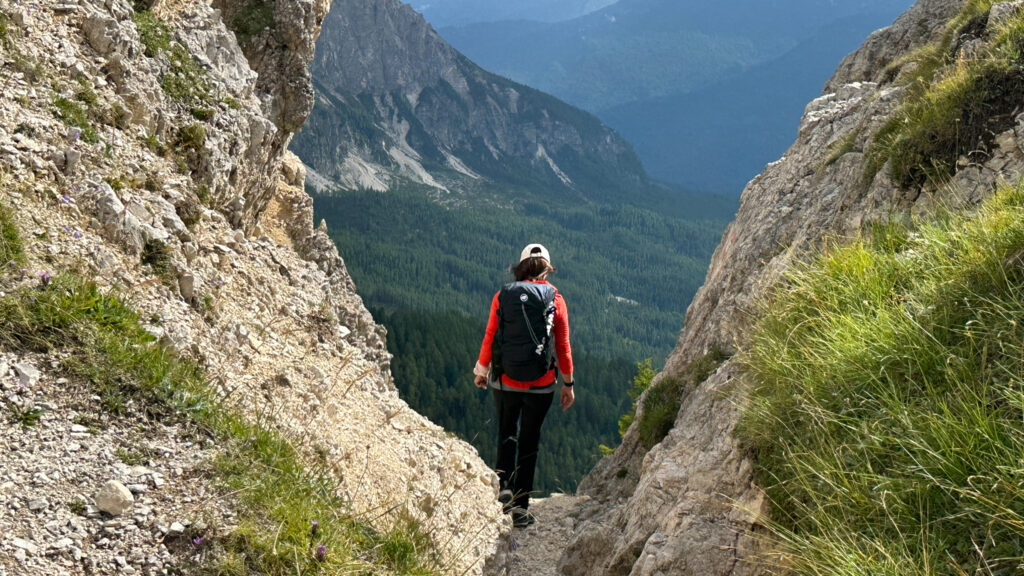 A Life Happens Outdoors community member hiking through a rocky mountain pass, representing adventure travel, reflection, and rediscovering yourself in the outdoors
