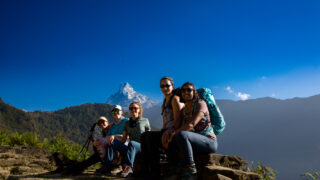 Group of women trekkers enjoying a mountain view during an adventure in Nepal