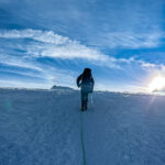 A Life Happens Outdoors community member trekking across a snowy landscape at sunrise, symbolising resilience, clarity, and finding purpose through adventure travel