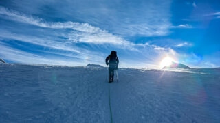 A Life Happens Outdoors community member trekking across a snowy landscape at sunrise, symbolising resilience, clarity, and finding purpose through adventure travel