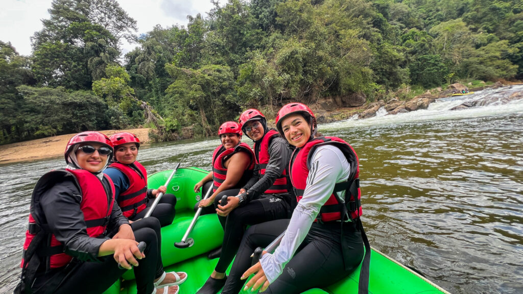 Life Happens Outdoors community members rafting through a rainforest river, capturing adventure travel, confidence, and the joy of reconnecting with yourself
