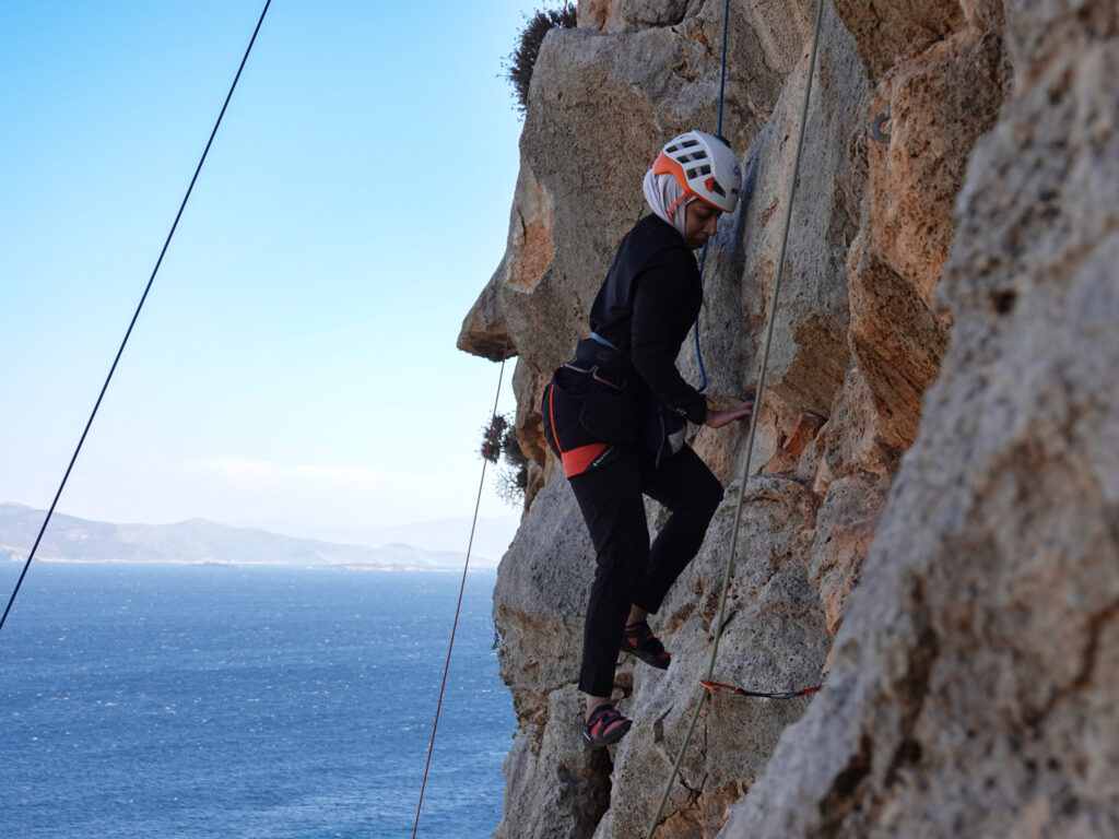 Climber on a sea cliff in Kalymnos during a rock climbing adventure vacation with Life Happens Outdoors