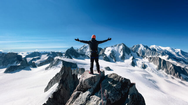 Climber above the Mont Blanc massif with Life Happens Outdoors, capturing overcoming fear through alpine adventure