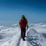 Climber walking along the Bosses Ridge on the Mont Blanc climb via the Goûter Route