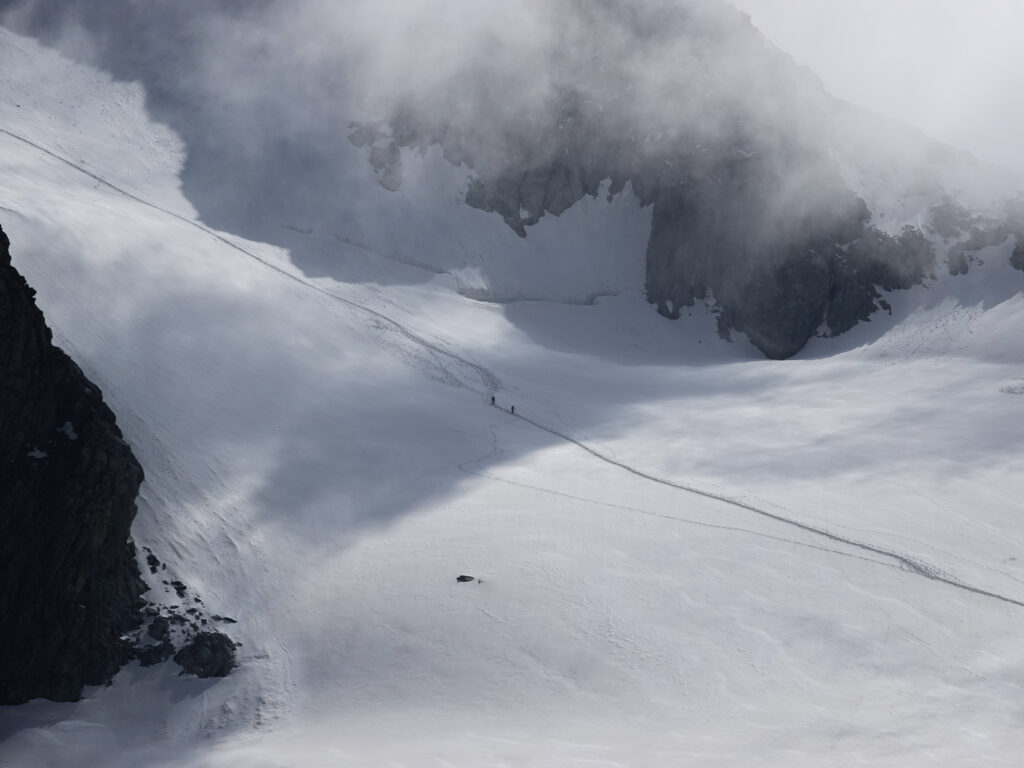 Climbers crossing a snowy glacier basin on Mont Blanc during a guided ascent