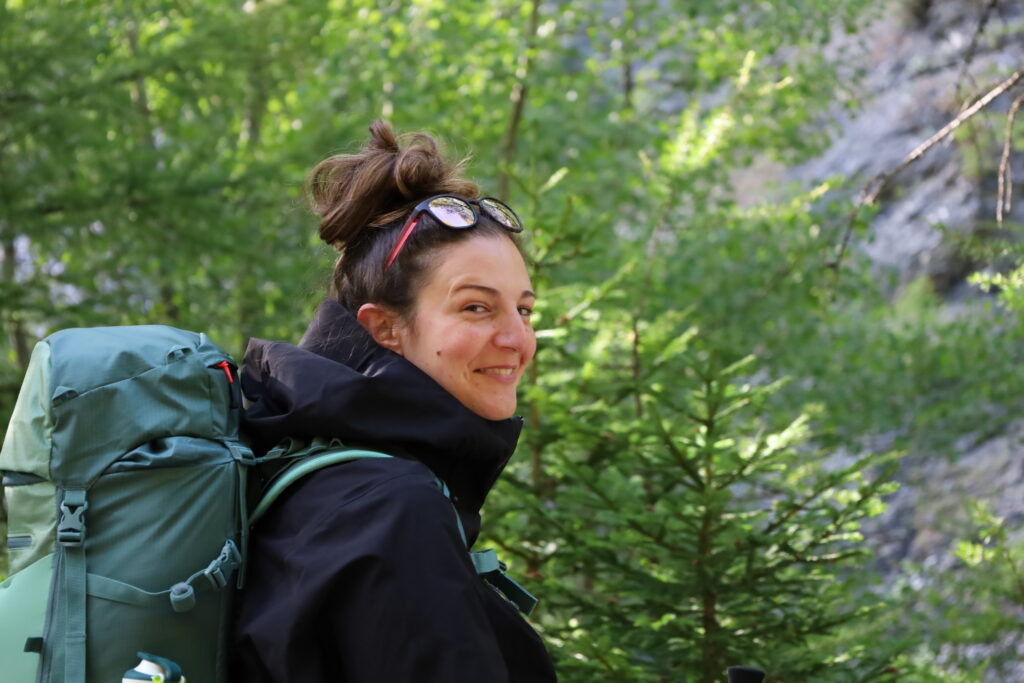 Hiker with backpack on a forest section of the Tour du Mont Blanc trail