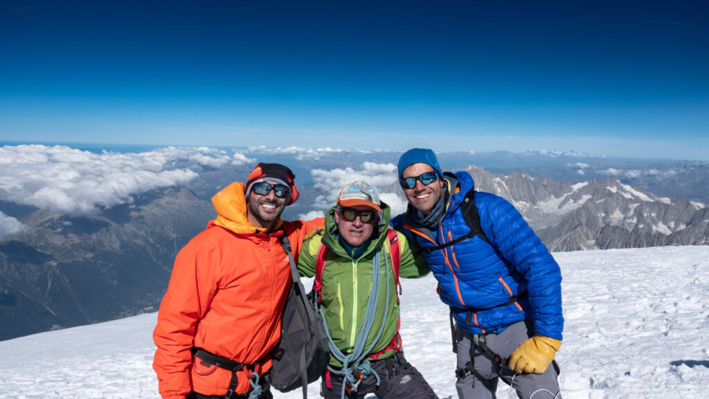 Climbers and guide on the Mont Blanc summit during a guided ascent