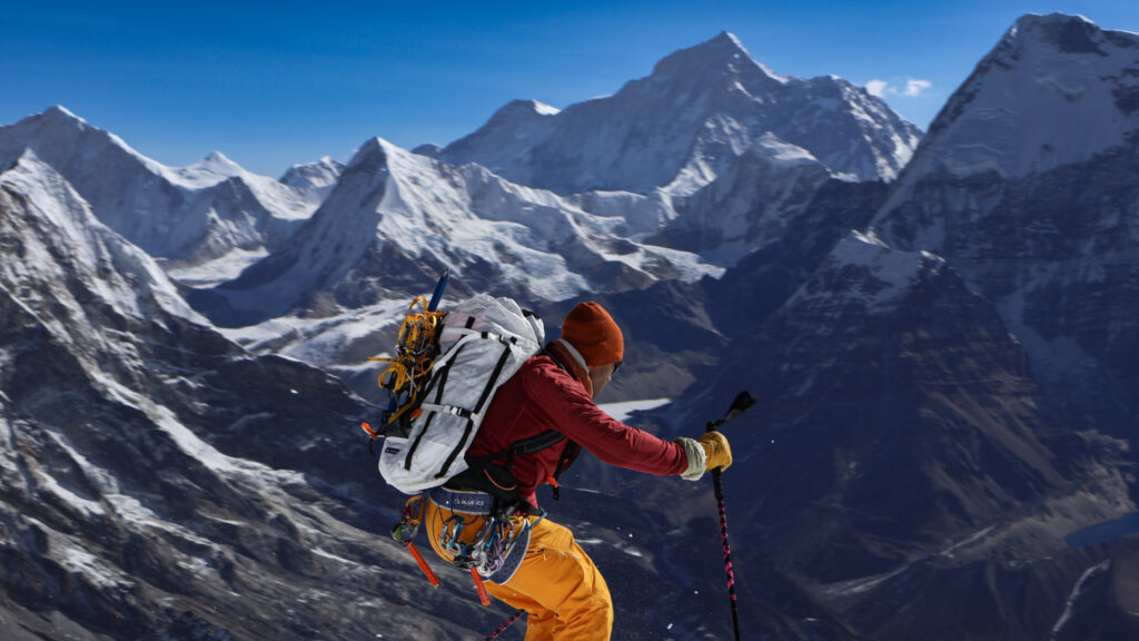 Skier making a turn on Mera Peak glacier during high altitude ski touring descent in the Himalayas