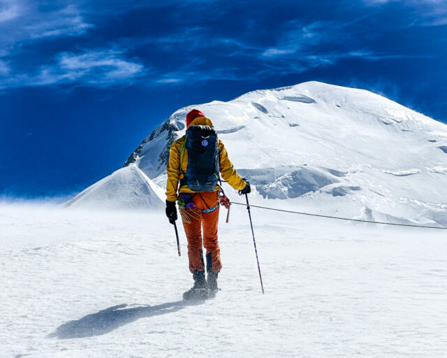 Climber approaching Mont Blanc in clear summer alpine conditions, showing the snow cover, weather window, and route conditions that shape the best time to climb.