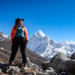 Life Happens Outdoors trekker standing on the Everest Base Camp trail with Himalayan peaks in the background