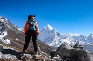 Life Happens Outdoors trekker standing on the Everest Base Camp trail with Himalayan peaks in the background