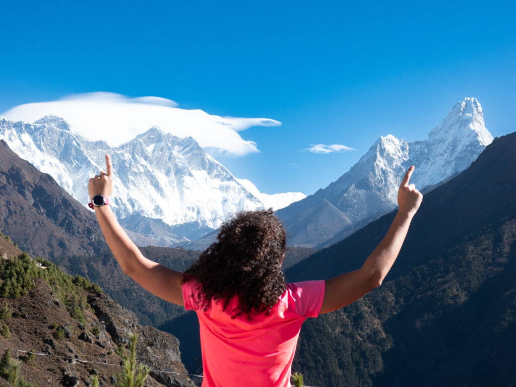 First time trekker pointing toward Mount Everest and Ama Dablam during the Everest Base Camp trek in Nepal