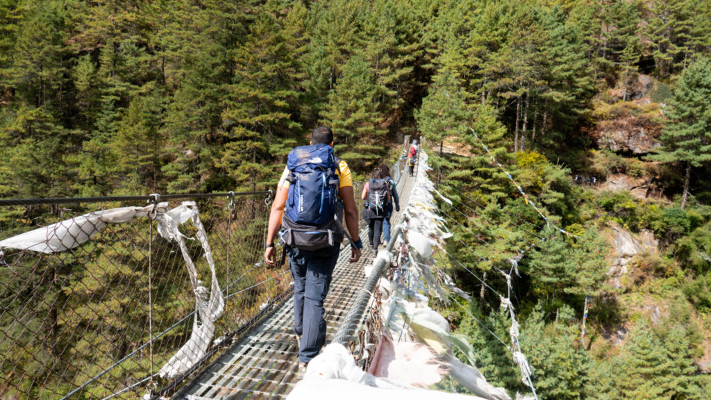 Trekkers crossing a suspension bridge on the Everest Base Camp route in the Khumbu region of Nepal