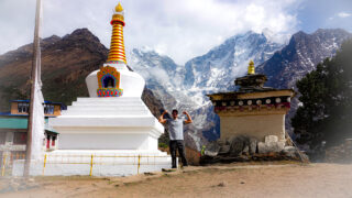 Buddhist stupa on the Everest Base Camp trail with Himalayan peaks in the background in Nepal