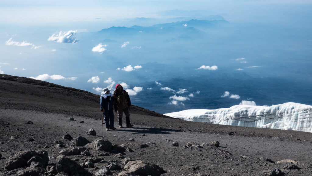 Climbers walking near a Kilimanjaro glacier during high altitude acclimatisation