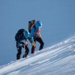 Life Happens Outdoors climbers training for Mont Blanc on steep alpine snow with ice axes and rope