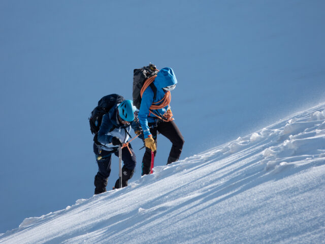Life Happens Outdoors climbers training for Mont Blanc on steep alpine snow with ice axes and rope
