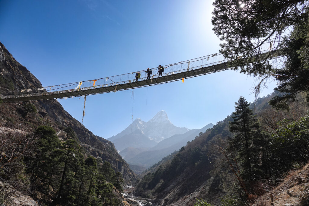 Trekkers crossing a suspension bridge on the Everest Base Camp trail in Nepal