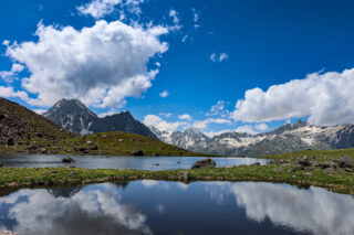 Alpine lake and mountain views on a Walker’s Haute Route style trek through the Swiss Alps