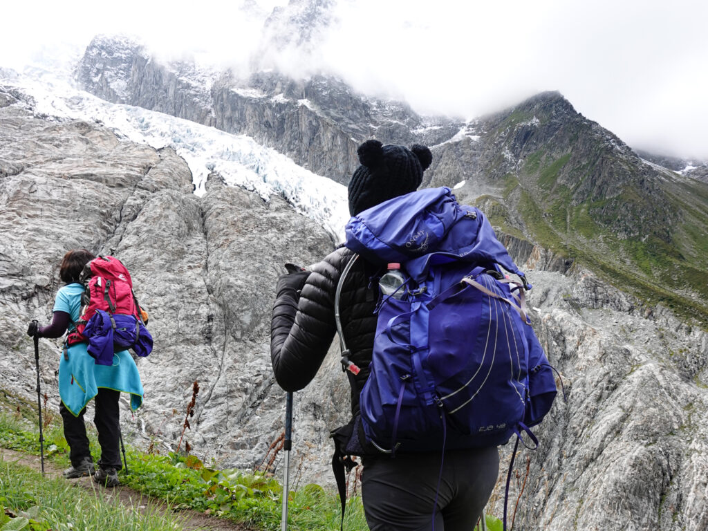 Trekkers looking toward a glacier from a high alpine trail on a Walker’s Haute Route style trek
