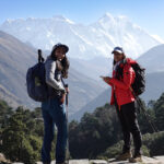 Trekkers on the Everest Base Camp trail with Himalayan mountains behind them