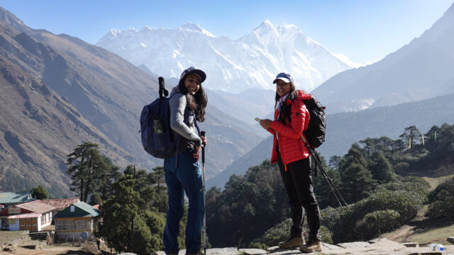 Trekkers on the Everest Base Camp trail with Himalayan mountains behind them