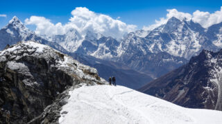 Climbers on a snow covered ridge in the Everest region during a Lobuche East climbing route in Nepal