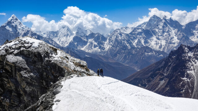 Climbers on a snow covered ridge in the Everest region during a Lobuche East climbing route in Nepal