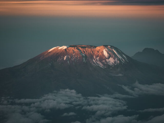 Mount Kilimanjaro at sunrise above the clouds, featured in the Moving Mountains documentary by Life Happens Outdoors.