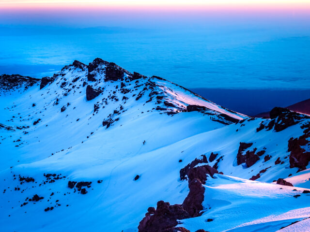 Snow-covered Kilimanjaro ridge above the clouds during the Moving Mountains documentary by Life Happens Outdoors.