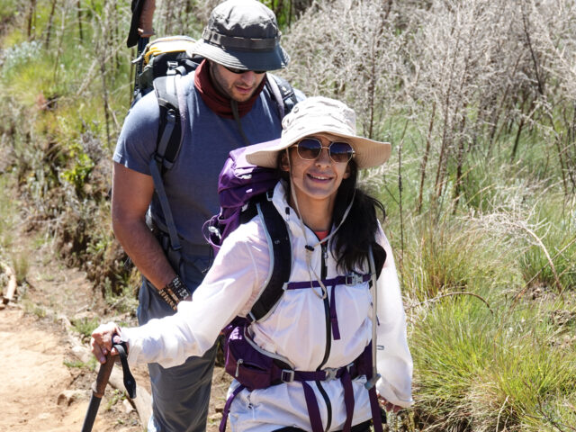 Raneen Faraidy hiking on Kilimanjaro with team support during the Moving Mountains documentary by Life Happens Outdoors.