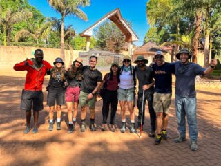 Life Happens Outdoors trekking group standing together in hiking gear.