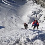 Climbers ascending fixed ropes above a glacier on Island Peak after trekking to Everest Base Camp
