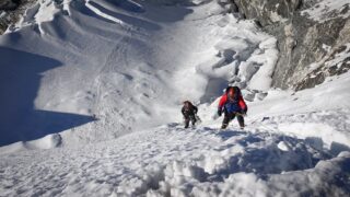 Climbers ascending fixed ropes above a glacier on Island Peak after trekking to Everest Base Camp